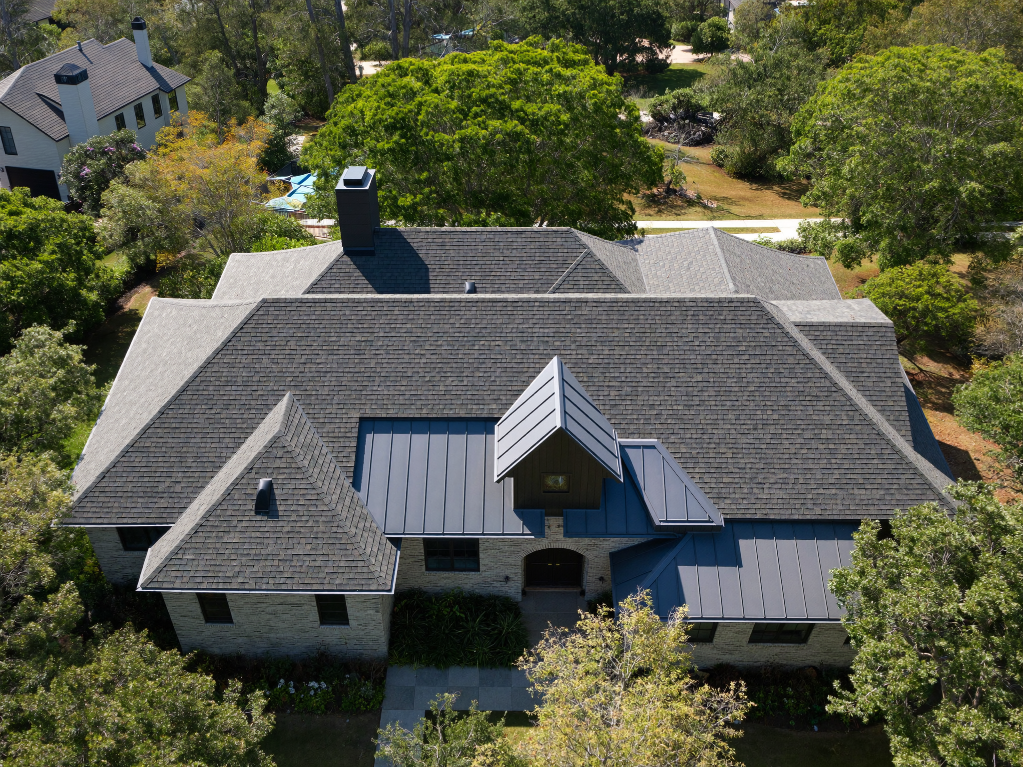 Aerial view of a complex architectural roof system on a luxury Triangle home