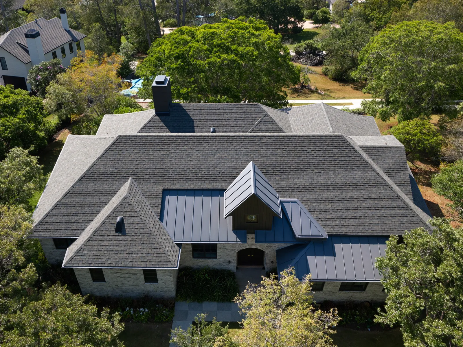 Aerial view of a complex architectural roof system on a luxury Triangle home