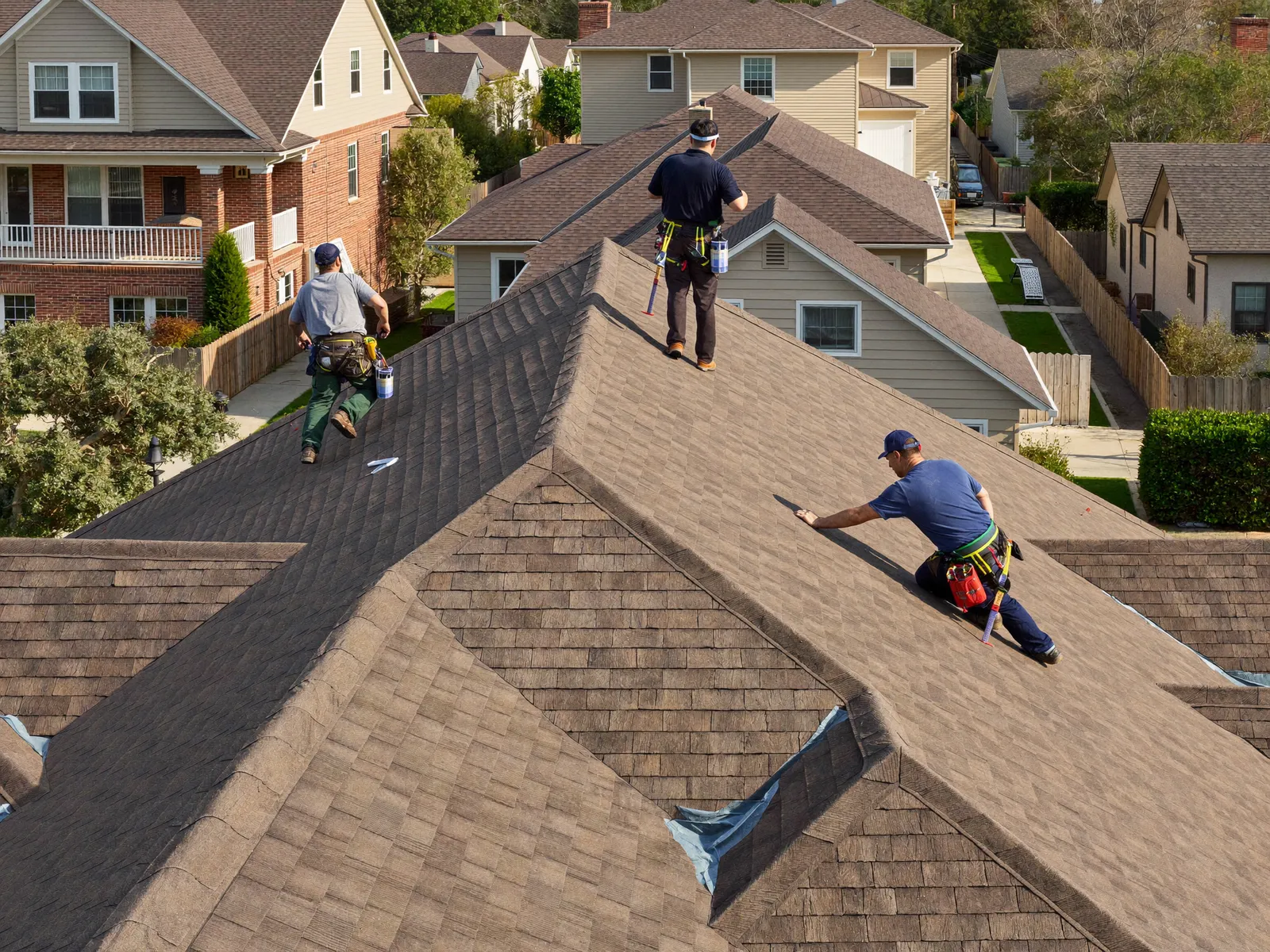 Roofing crew installing a premium roof on an upscale North Carolina home