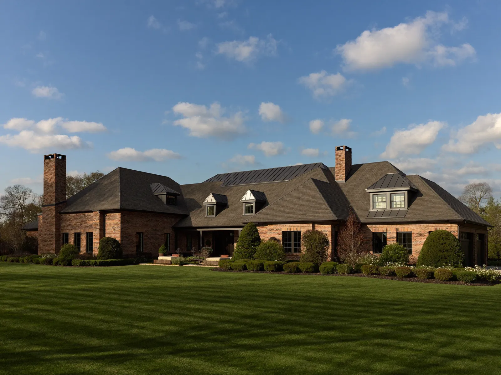Custom brick estate home with a new architectural-shingle roof in the North Carolina Triangle