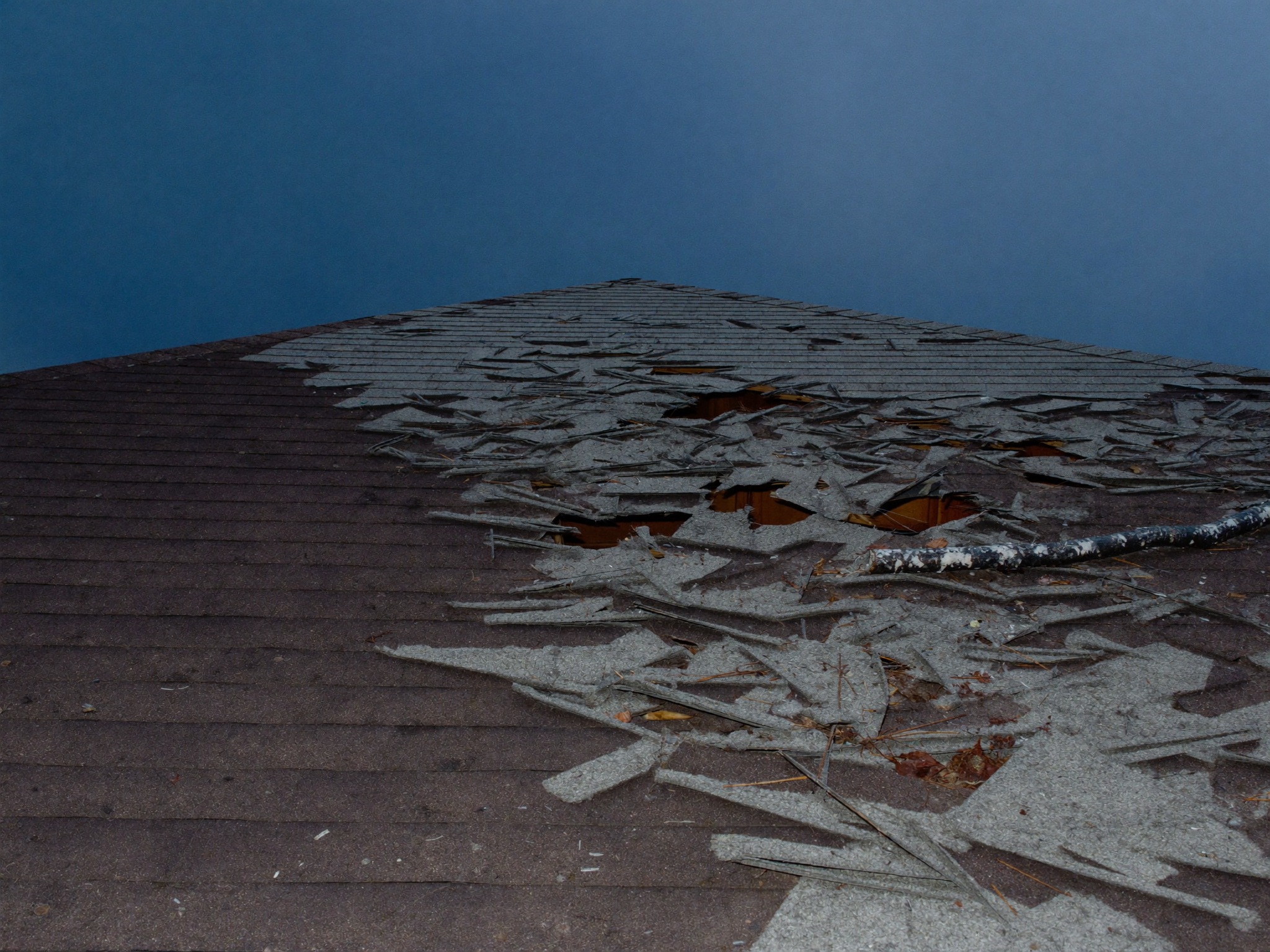A North Carolina roof with visible storm and hail damage after a passing storm